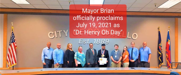 Dr. Henry Oh, Mayor Brian, and City Council of Pocatello stand in a line.