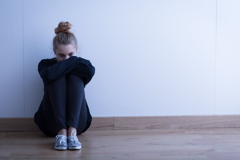 Sad woman with depression sitting on the floor-2