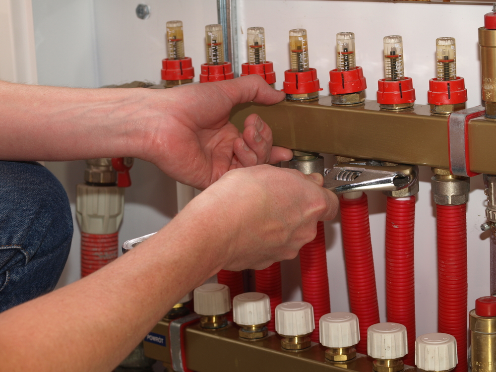 Man hands fixing a thermal insulation in boiler room